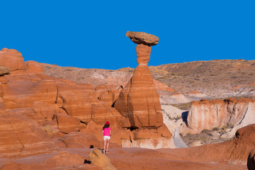 A hiker among hoodoos sandstone formations in Utah, USA 