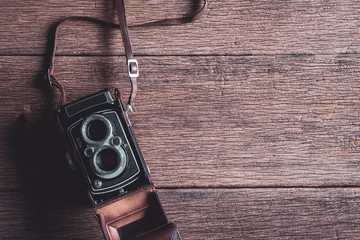 Old retro camera on old wooden background with copy space, Top view