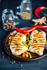 grilled turkey fillet with vegetables, pepper and spices on a plate