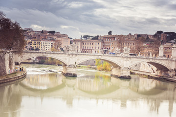 Obraz premium Rome, Italy, December 2018: View of the Tiber river in Rome, Italy ruring overcast day with ancient city architecture