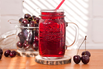 Homemade fresh cherry juice in a jar. Rustic style, healthy, organic, diet food. Selective focus.
