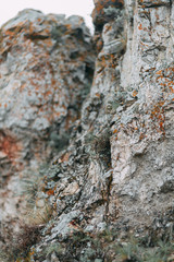 The bends of the river and the beautiful cliffs. Summer nature and texture of the stones with streaks.