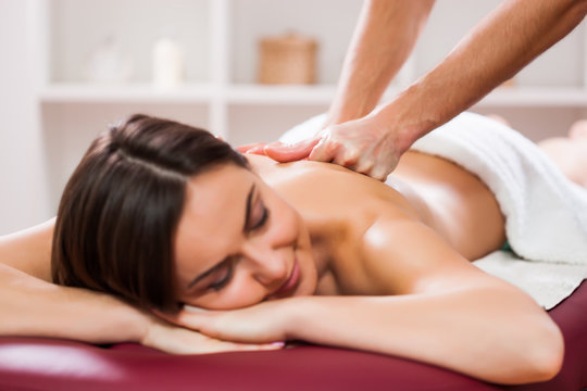 Young woman is enjoying massage on spa treatment. 