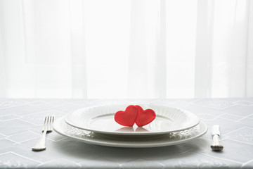 Valentines day table place setting with two hearts. Space for text. Invitation for a date.