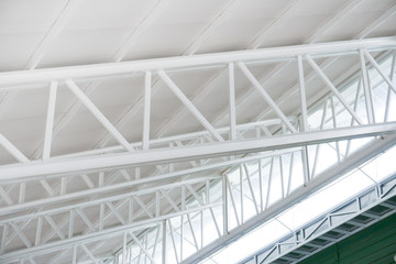 Large steel structure truss, roof frame and metal sheet in building construction site