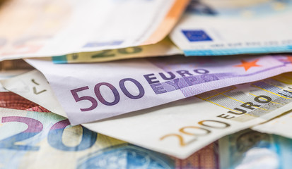 Euro banknotes in detail on the pile of other nominal banknotes