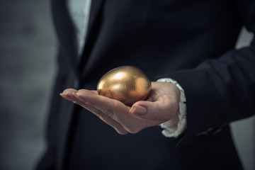 golden egg in female hand