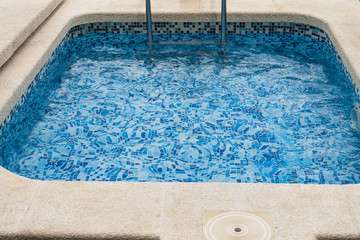 Empty children's swimming pool with a blue ceramic bottom