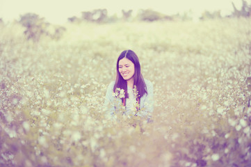 beautiful asian young woman sitting in white  flowers field
