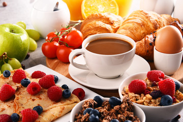 Breakfast served with coffee, juice, croissants and fruits