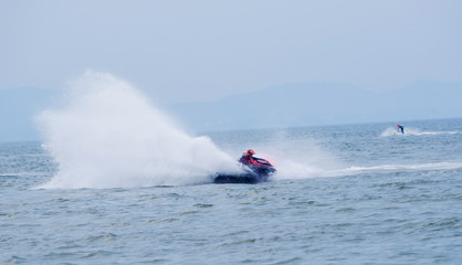 Obraz premium Young guy riding on the jet ski in gulf of Siam