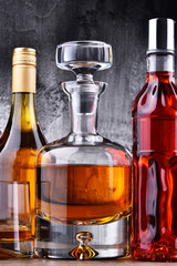 Carafe and bottles of assorted alcoholic beverages.
