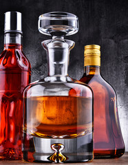 Carafe and bottles of assorted alcoholic beverages.