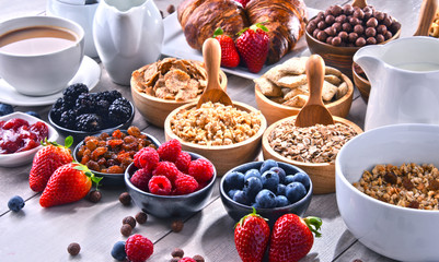Different sorts of breakfast cereal products and fresh fruits