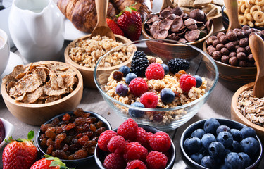 Different sorts of breakfast cereal products and fresh fruits