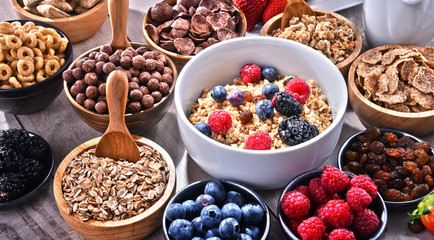 Different sorts of breakfast cereal products and fresh fruits