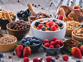 Different sorts of breakfast cereal products and fresh fruits