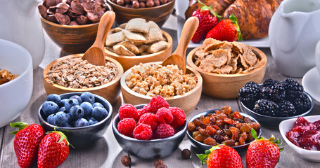 Different sorts of breakfast cereal products and fresh fruits