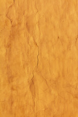 vertical textured bright yellow wall with lots of cracks and scratches. abstract background for design