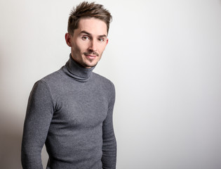 Fototapeta premium Handsome young elegant man in grey golf.