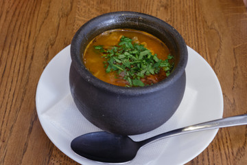 Traditional Georgian soup Kharcho with meat and rice in a pot