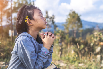 Little girl praying. Peace, hope, christian concept.