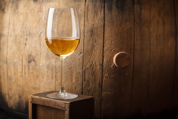 White wine near a barrel