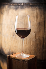 Red wine near a barrel