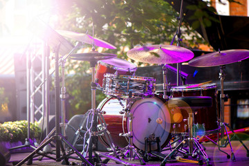 Modern drum set on stage, prepared for playing. Setting up the sound system. Concert is just about...