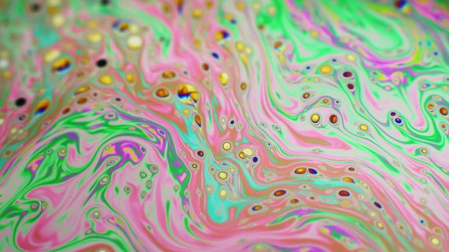 Psychedelic background of motion surface of colorful soap bubble