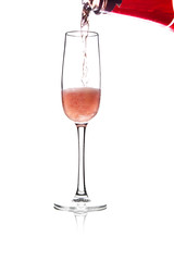 pouring pink wine into glass, isolated on white background