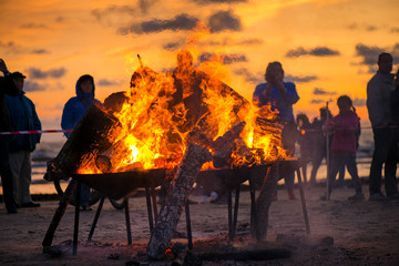 Large burning bonfire with soft glowing flame and sparkles flying all around. Romantic summer...