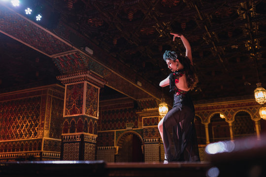 Woman dancing on scene in beautiful room