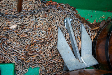 Rusty chain and anchor  on boat deck.