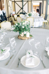 Decor wedding table in the cafe. Floristry and glass glasses at the wedding.