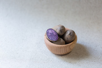 Raw colorful potatoes. Vitelotte