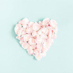 Flowers composition. Rose flower petals on pastel blue background. Valentine's Day, Mother's Day concept. Flat lay, top view, square