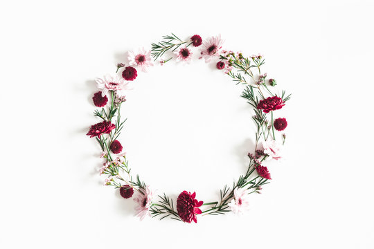 Flowers composition. Wreath made of eucalyptus leaves and pink flowers on white background. Flat lay, top view, copy space