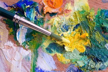 Vibrant multi-coloured artists oil or acrylic paints palette and paintbrush