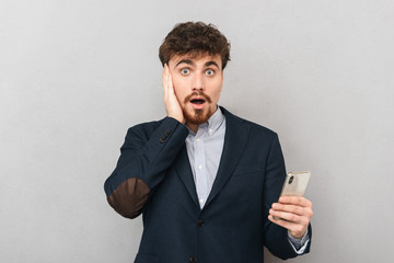 Shocked young businessman wearing suit