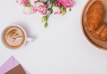 Obraz na płótnie Canvas Creative frame with coffee, croissants and flowers