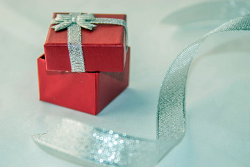 Valentines day! Red box for a gift with silver ribbon,  isolated on a white background. 