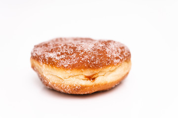 Traditional German or Austrian fried donuts with no hole, so called Krapfen, Berliner or Pfannkuchen with cinnamon sugar and filled with rose hip, raspberry or strawberry jam, party or carnival food