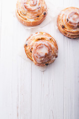Cinnamon rolls buns on a white marble wooden background. Bakery concept. Breakfast and brunch. Flatlay. Minimalistic photo. Overhead. Copy space