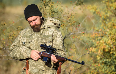 Bearded man hunter. Military uniform. Army forces. Camouflage. Hunting skills and weapon equipment....