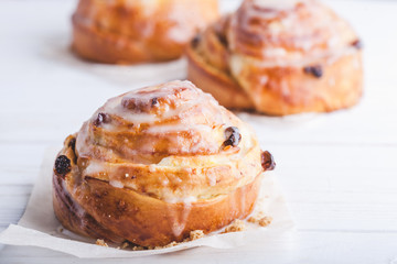 Cinnamon rolls buns on a white marble wooden background. Bakery concept. Breakfast and brunch. Flatlay. Minimalistic photo. Overhead. Copy space