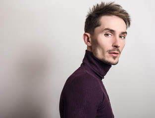 Obraz premium Handsome young elegant man in violet golf.