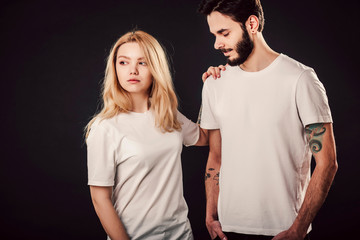 T-shirt design, people concept - closeup of young woman and man in blank white shirt, front isolated. Mock up template for design print.