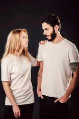 Fototapeta premium T-shirt design, people concept - closeup of young woman and man in blank white shirt, front isolated. Mock up template for design print.