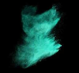 Explosion of colored powder on black background